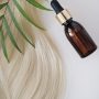 Curl female hair, balm or hair mask isolated on white background . oil bottle and recovery hair.